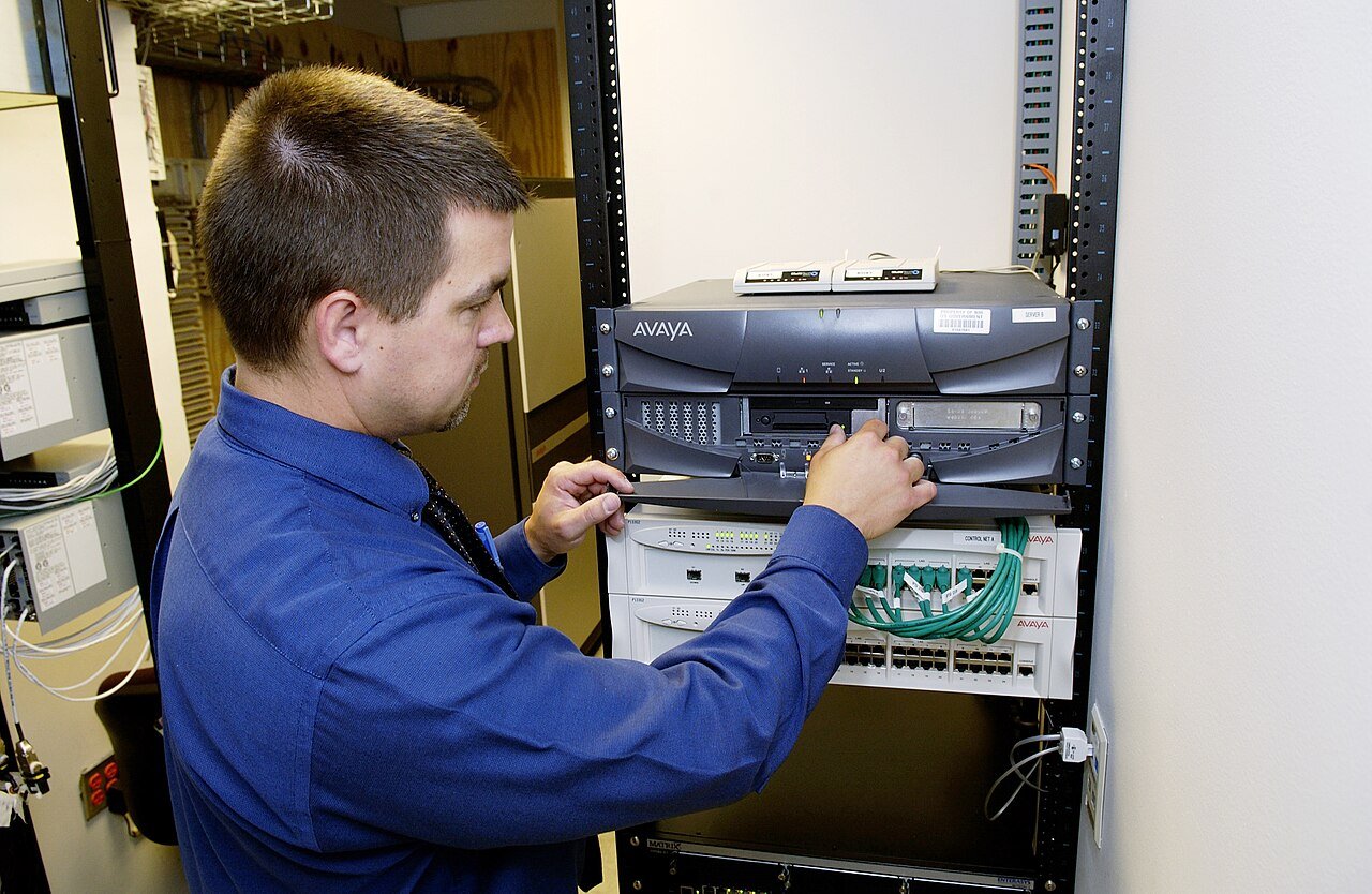 Technician working with network infrastructure in a data center