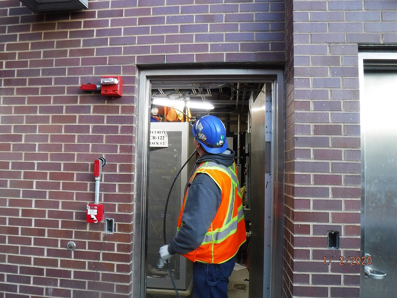 Crew installing fiber optic cable in a utility environment